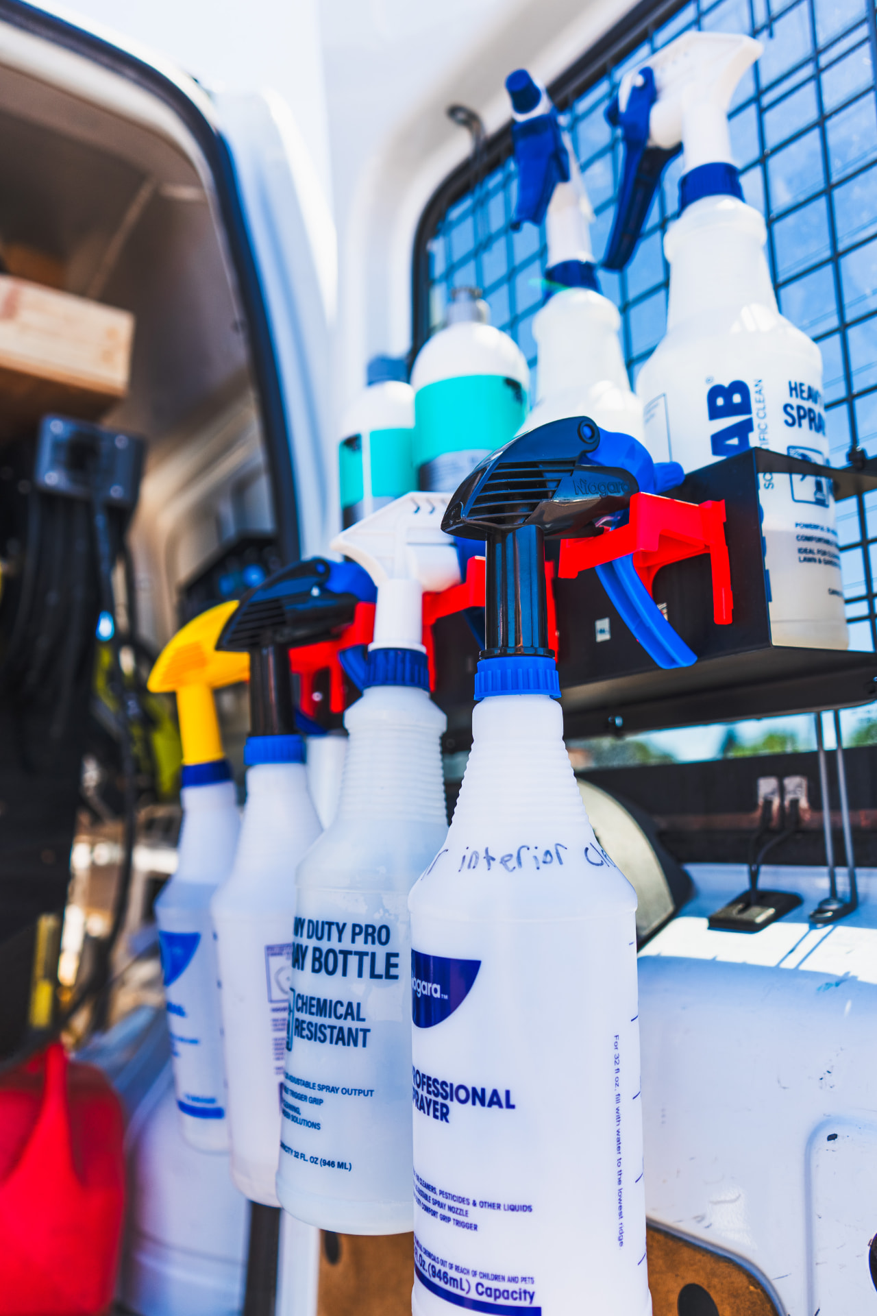 Professional detailing chemicals racked inside the mobile detailing van